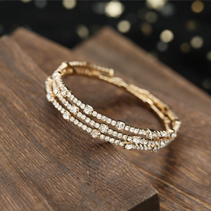 Elegant gold three-row rhinestone stretch bracelet with sparkling crystals for bridal wear
