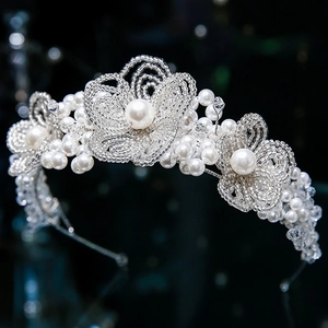 Macro detail of bridal headband featuring handcrafted white pearls and silver beads