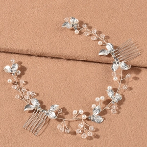 Elegant silver bridal hair vine with crystals and pearls on textured camel fabric