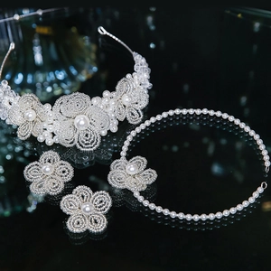 Detail of luxury bridal headband with woven pearl flowers and silver wire craftsmanship