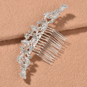 Detailed view of silver bridal hair comb with rhinestone floral and leaf vine motifs