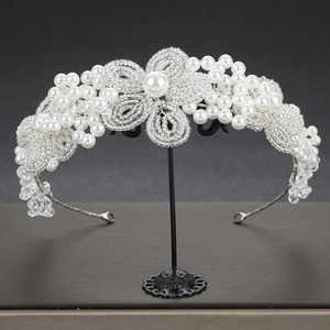 Detailed close-up of handmade bridal headband with white pearls and crystal flower beads