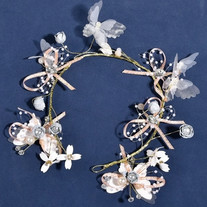 Detailed handmade headpiece with delicate silk butterflies, floral fabric, and soft pearls