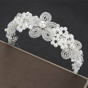 Elegant bridal headband with white crystals and pearls for luxury wedding hair styling