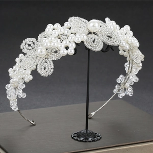 Detail shot of the bridal headband with woven white pearls and sparkling crystal beads