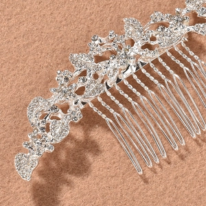 Close-up of silver bridal hair comb with vintage floral rhinestones on felt background