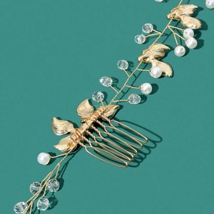 Macro detail of bridal hair comb featuring golden leaves, pearls and crystal beads
