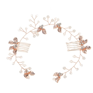 Detail of rose gold bridal hair comb with pearls, crystals and metallic leaf ornaments