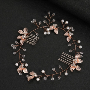 Detail of rose gold bridal hair comb with pearls, crystals, and metallic leaf design