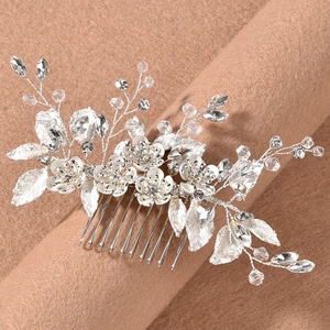 Detailed view of silver bridal hair comb with crystal flowers and leaf rhinestones