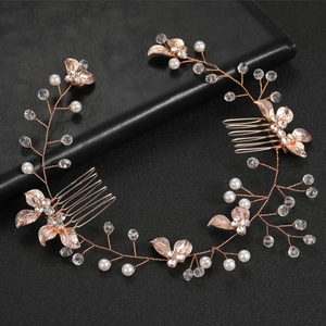 Detail of rose gold bridal hair comb with pearls, crystals, and metallic leaves decoration