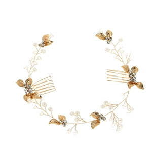 Detail of bridal hair comb with golden leaves, crystals, and pearls in vine design
