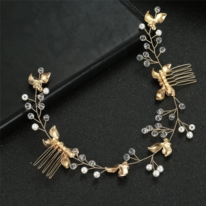 Detailed view of handmade bridal hair comb with gold leaves, pearls and crystals