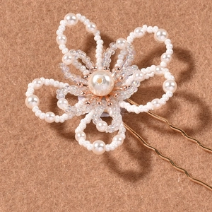 Handmade bridal hair pin with white pearl flower petals and golden metal U-shaped fork