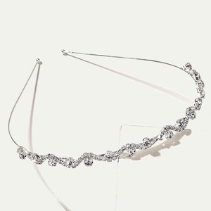 Silver wavy headband with shimmering crystals in a minimalist crown style design