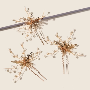 Three-piece gold bridal hair pin set with white pearls and delicate metal leaves