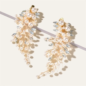 Elegant bridal hair clips with white pearls and blue crystal vines on a gold wire base