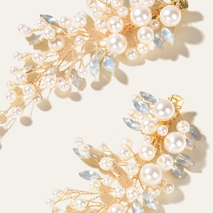 Elegant bridal hair clips with white pearls and blue crystals on golden wire branches