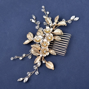 Detail of silver leaf bridal hair comb with marquise crystals and white lacquer flowers