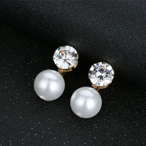 Sparkling zircon and white pearl drop earrings with elegant gold setting for wedding