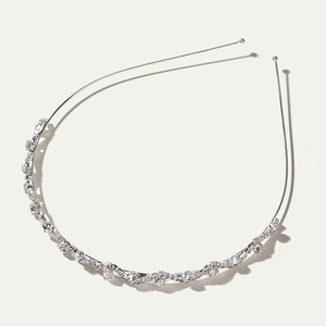 Silver bridal headband featuring wavy rows of sparkling rhinestones on a slim metal frame