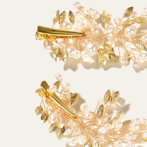 Elegant bridal hair clips with golden wings, white pearls and crystal rhinestone details
