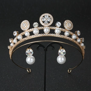 Close-up of luxury bridal tiara set with gold alloy, zircon and white pearls on black stand