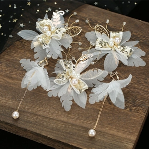 Elegant bridal butterfly hair clip with gold sequins and pearls for wedding hair styling