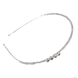 Detail shot of silver bridal headband featuring sparkling rhinestones and clear round crystals