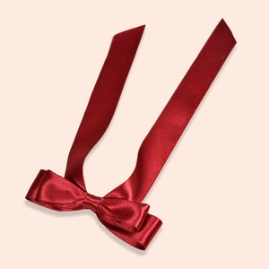 Elegant deep red satin bow hair clip with long streamers for bridal wedding hairstyles