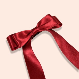 Elegant deep red satin bow hair clip with long ribbons for wedding and bridal hairstyles