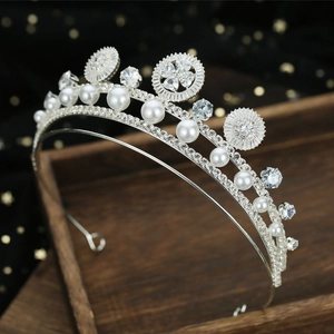 Macro detail of silver bridal tiara with white pearls, zircon stones and floral patterns