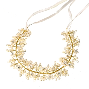 Handmade bridal headpiece with white pearls and gold crystal vine on white background