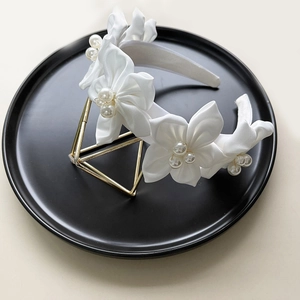 Elegant white camellia headband with silk flowers and pearls for bridal wedding styling