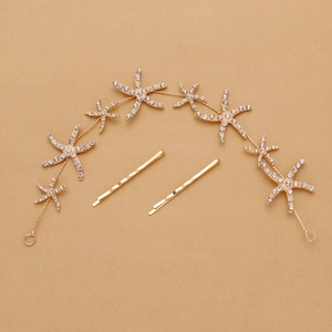 Macro shot of gold starfish hairband and clips with sparkling rhinestones decoration