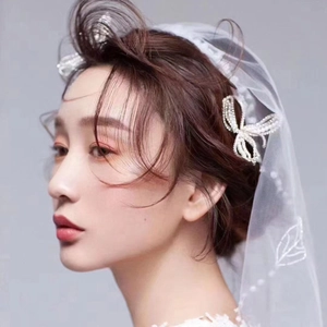 Elegant bridal hair accessory set with rhinestone butterfly clip and white floral veil