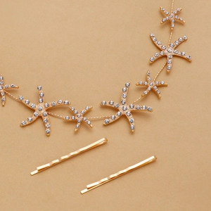 Detail view of starfish hair vine with rhinestones and golden wavy hair clips set