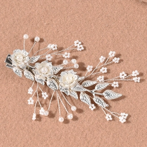 Silver leaf bridal hair clips set with white pearls and metal flower design