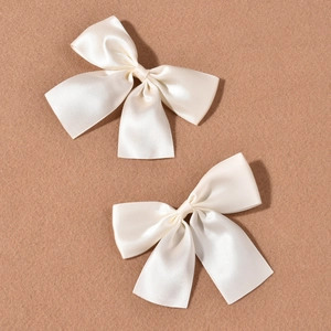 Set of two creamy white satin bow hair clips for bridal wedding hairstyle accessories