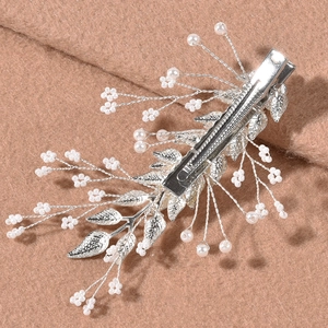 Silver bridal hair pins with leaf branches and white pearls for wedding hairstyles