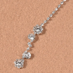 Detailed close-up of sparkling silver rhinestone forehead chain jewelry with floral motifs
