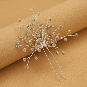 Détail d'une épingle à cheveux de mariée en U avec perles champagne et fils d'argent