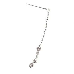 Close-up of silver tassel hair clip with sparkling rhinestones and floral clusters