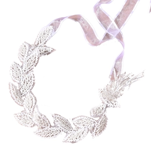 Handmade beaded bridal headband with white pearls and leaves on a lavender ribbon