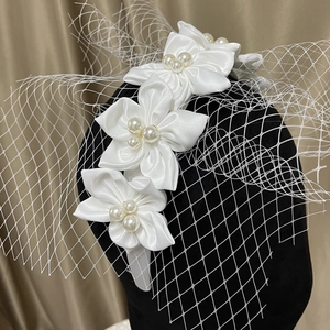 Elegant white satin floral headband with pearls and delicate mesh veil for bridal wedding
