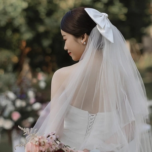 Elegant white satin bow wedding veil with layered mesh tulle for bridal hairstyles