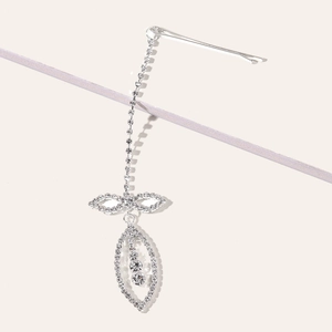 Detail of silver tassel hair clip with sparkling rhinestones and butterfly charm
