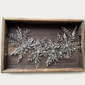 Elegant bridal silver star hair vine with rhinestones on a rustic wooden tray