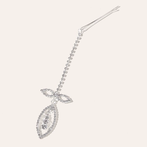 Detail of silver rhinestone bow tassel hair clip with leaf pendant and sparkling crystals