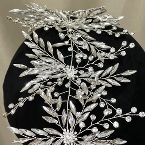 Sparkling silver bridal headband with crystal stars and rhinestones for wedding hairstyling